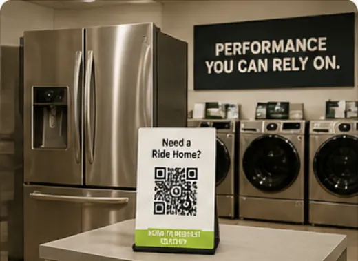 Appliance store with a QR delivery placard near washers and refrigerators